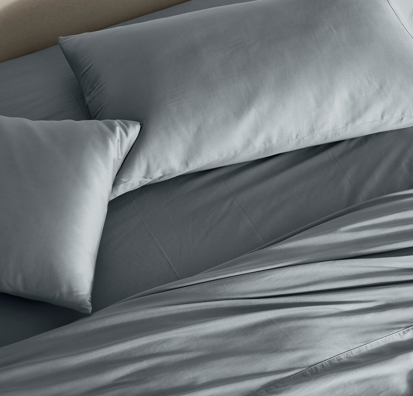 Detail image of bed made with Signature Hemmed Sheet Set in Bluestone