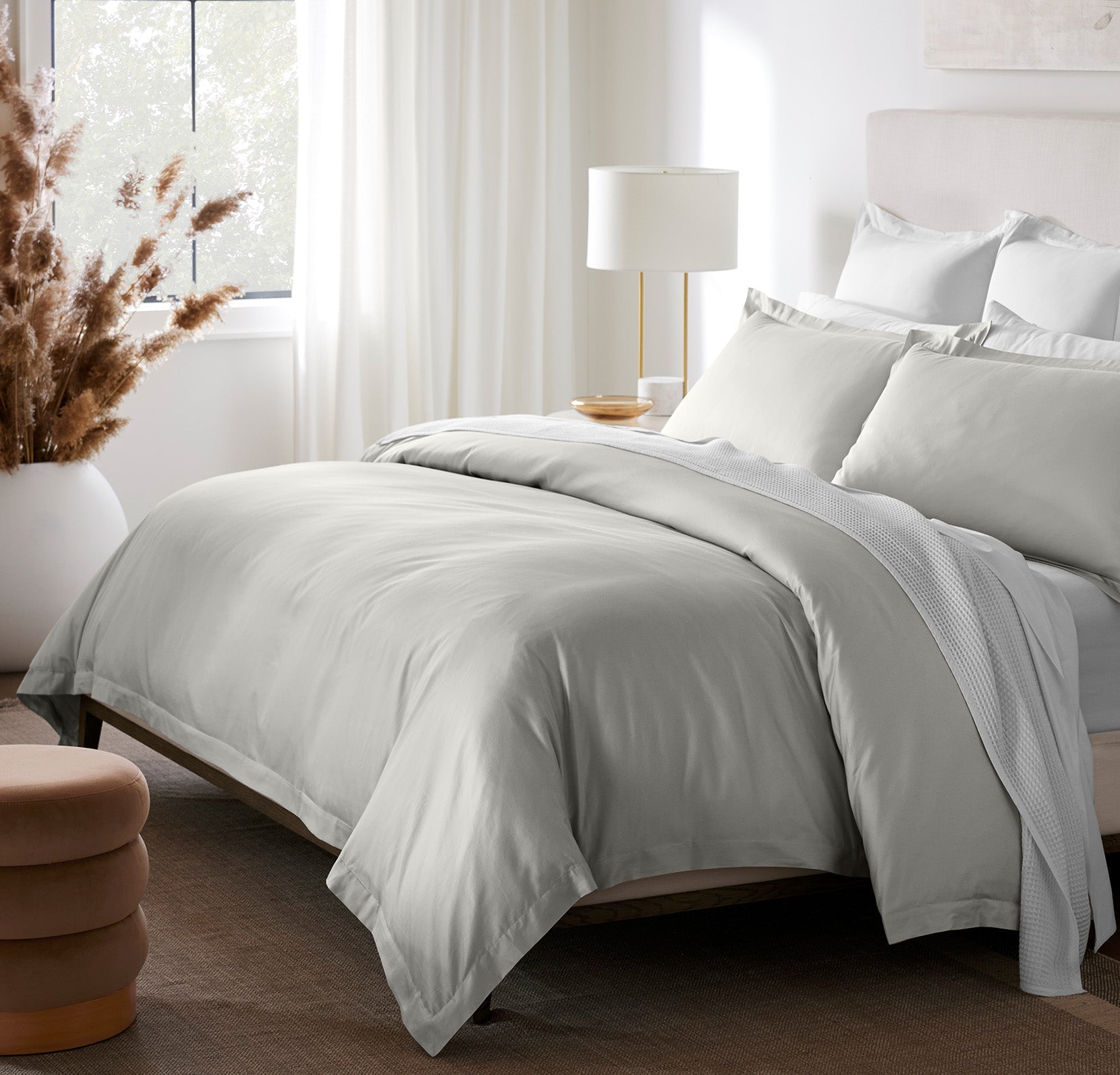 Lifestyle image of bed made with Hemmed Duvet Set in Mist