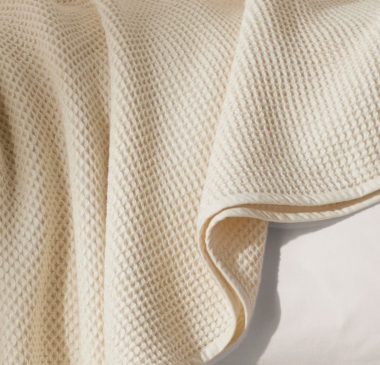 Detail image of bed made with Waffle Bed Blanket in Natural