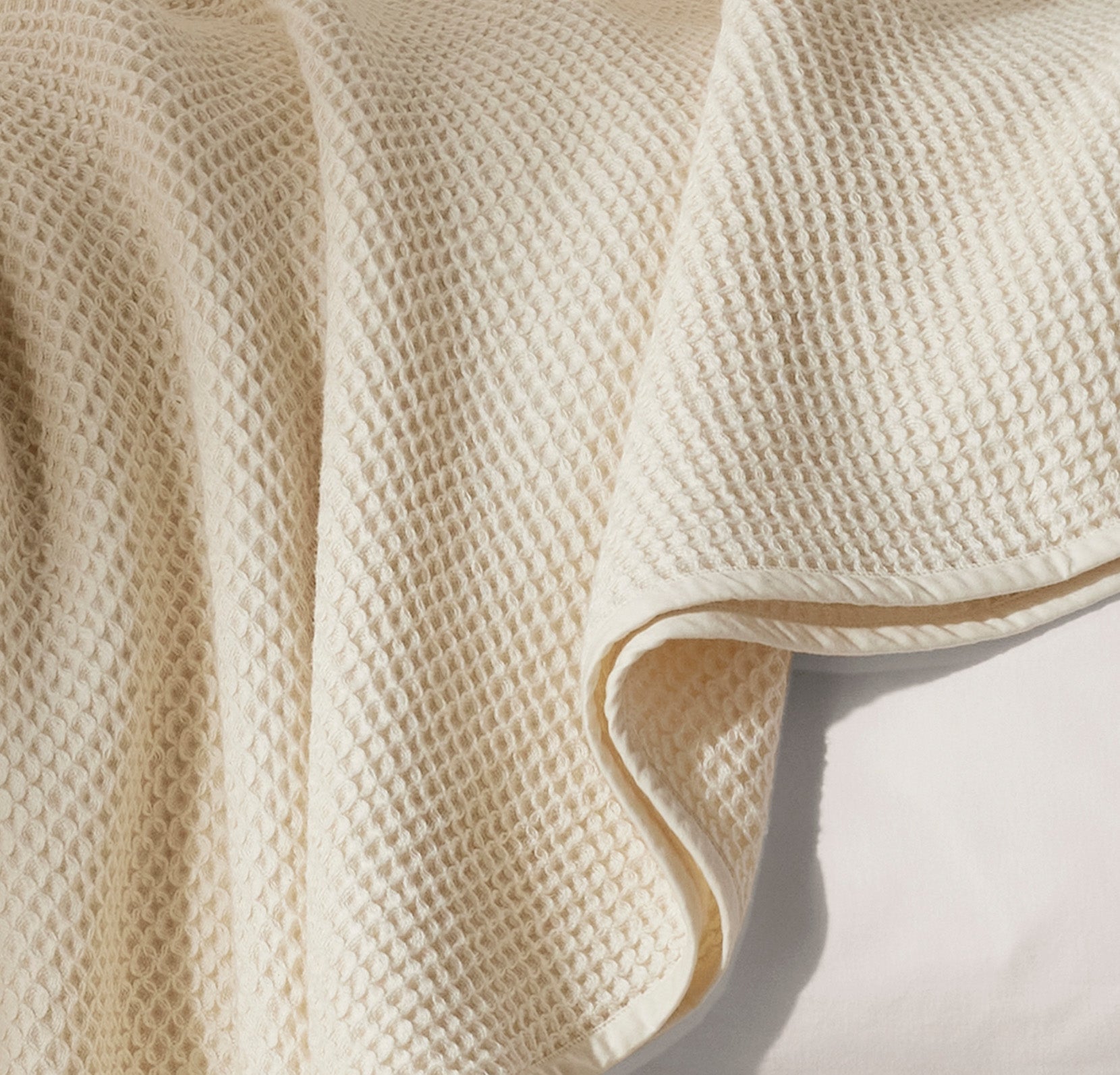 Detail image of bed made with Waffle Bed Blanket in Natural