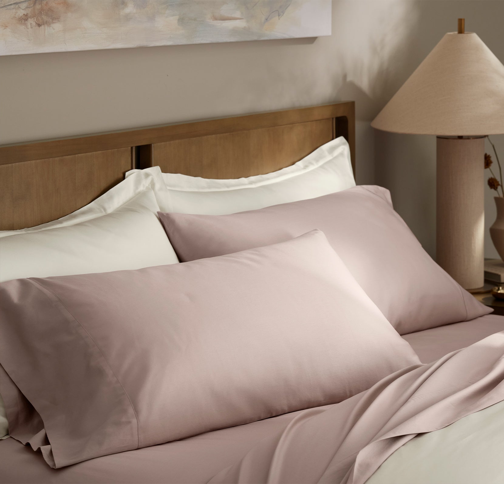 Lifestyle image of bed made with Signature Hemmed Sheet Set in Dusty Rose