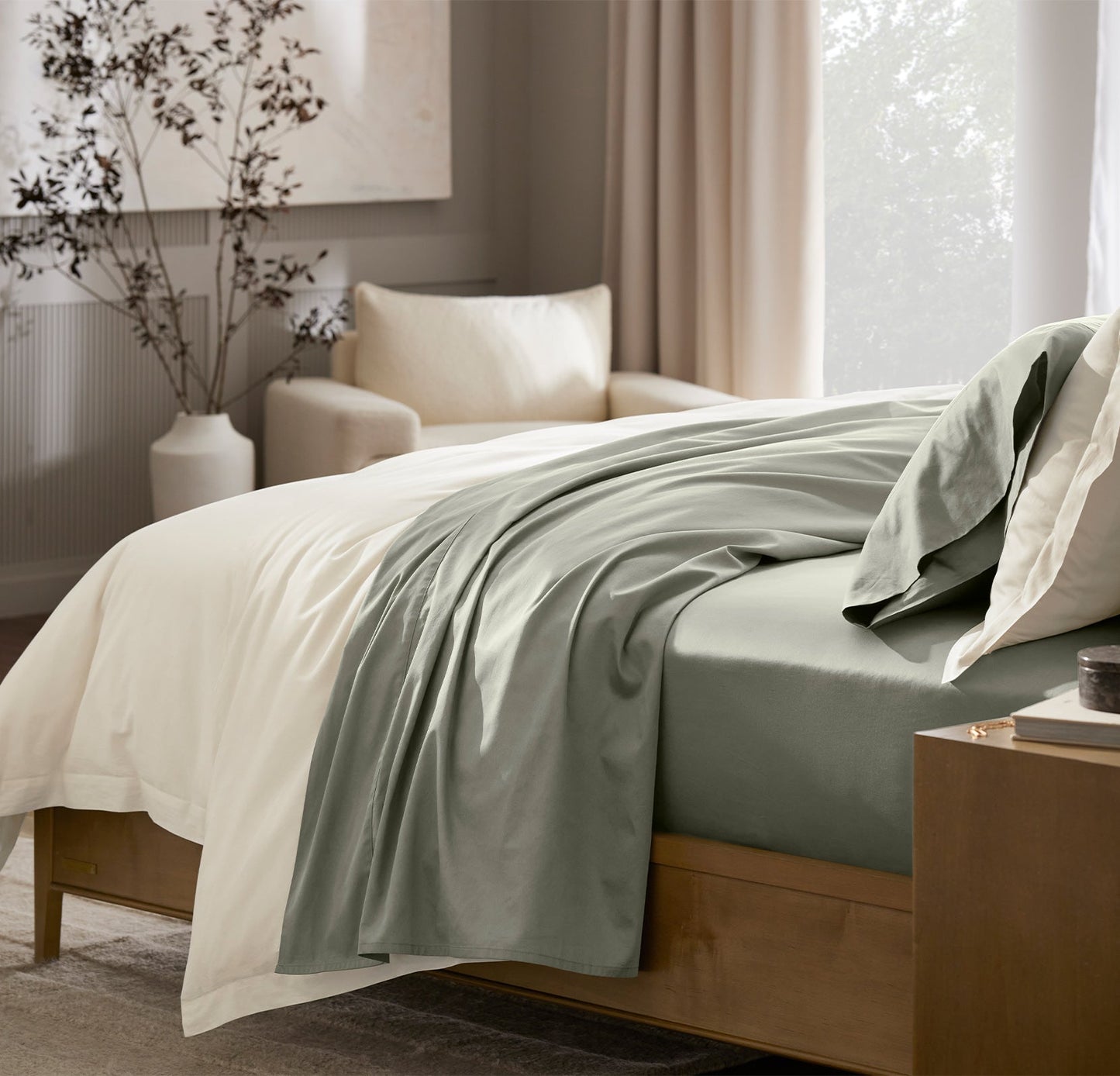 Lifestyle image of bed made with Signature Hemmed Sheet Set in Sageleaf